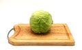 Head of cabbage on a wooden ÃÂutting board on a light background.