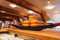 The head of cheese on the shelves of warehouse in netherlands open sky museum Zaanse schans. Production of Dutch cheese