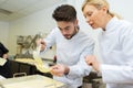 head chef with apprentice in kitchen Royalty Free Stock Photo