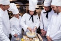 Head chef teaching his team to prepare a dough Royalty Free Stock Photo
