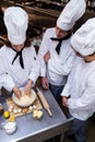 Head chef teaching his team to prepare a dough Royalty Free Stock Photo