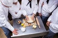 Head chef teaching his team to prepare a dough Royalty Free Stock Photo