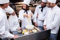 Head chef teaching his team to prepare a dough Royalty Free Stock Photo