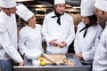 Head chef teaching his team to prepare a dough Royalty Free Stock Photo