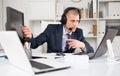 Head of the company conducts online negotiations with business partners in headphones