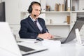 Head of the company conducts online negotiations with business partners in headphones