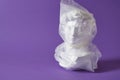 head of david in a transparent plastic bag on a purple background copy space Royalty Free Stock Photo