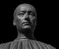 Head detail of the ancient man sculpture. Stone face isolated on black background. Antique marble statue of mythical