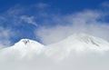 Head of Elbrus mountain viewed through fog and clouds Royalty Free Stock Photo