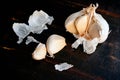 Peeling and Sectioning a Head of Garlic on a Wood Table