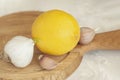 Head of garlic with slices and lemon on wooden cutting board close-up, folk remedies for flu and colds, concept of Royalty Free Stock Photo