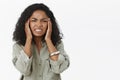 Head goes round from hangover. Portrait of displeased intense african american young woman with curly hair frowning