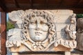 Marble tablet with ancient stone carving of Medusa Head. Royalty Free Stock Photo