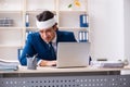 Head injured male employee working in the office Royalty Free Stock Photo