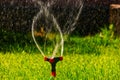Head of lawn sprinkler irrigation system with flow of water fly in an air with copyspace Royalty Free Stock Photo