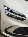 Head lights of white all-electric Hyundai Genesis GV60 car model in Studio Frankfurt, korean passenger Electric SUV vehicle in