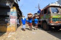 Head load workers unloading gunny bags from a truck in the market