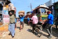 Head load workers unloading gunny bags from a truck in the market