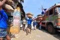 Head load workers unloading gunny bags from a truck in the market