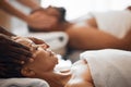 Head massage, spa bed couple and relax on vacation, holiday or retreat with happiness, peace or zen. Black woman Royalty Free Stock Photo
