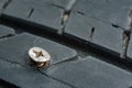 Close up metal screws nails embroidered in tires Royalty Free Stock Photo