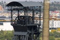 Head of the mining tower and a chimney with Ostrava center in the background Royalty Free Stock Photo