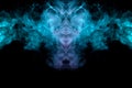The head of a monster with a skull in the form of a pattern from a ghost or a mystical creature from green and pink smoke on a