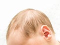 Head of the newborn baby first hear on white background, baby ear close up, macro shot of the hearing aid, earache, Royalty Free Stock Photo