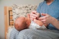 Head of a newborn close up. The father holds in the hands of the infant and copy space. Baby care concept Royalty Free Stock Photo