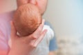 Head of a newborn close up. The father holds in the hands of the infant and copy space. Baby care concept Royalty Free Stock Photo