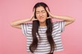 Head pain. Portrait of unhealthy girl with brunette hair in striped t-shirt clutching head, suffering severe headache