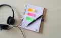 Head phone note and pen on table desk at office Royalty Free Stock Photo