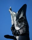 Head of the pike sculpture Laulupuut in front of the Helsinki Music Centre and a seagull