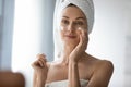 Smiling woman grooming herself after showering in bathroom. Royalty Free Stock Photo