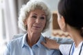 Head shot caring nurse supporting beautiful older woman, touching shoulder Royalty Free Stock Photo