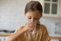 Head shot of cute little girl drinking fresh mineral water Royalty Free Stock Photo