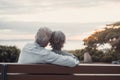 Head shot close up portrait happy grey haired middle aged woman with older husband, enjoying sitting on bench at park. Bonding Royalty Free Stock Photo