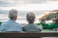 Head shot close up portrait happy grey haired middle aged woman with older husband, enjoying sitting on bench at park. Bonding Royalty Free Stock Photo