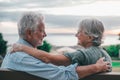 Head shot close up portrait happy grey haired middle aged woman snuggling to smiling older husband, enjoying sitting on bench at Royalty Free Stock Photo