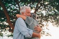 Head shot close up portrait happy grey haired middle aged woman snuggling to smiling older husband, enjoying tender moment at park Royalty Free Stock Photo