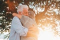 Head shot close up portrait happy grey haired middle aged woman snuggling to smiling older husband, enjoying tender moment at park Royalty Free Stock Photo