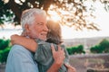 Head shot close up portrait happy grey haired middle aged woman snuggling to smiling older husband, enjoying tender moment at park Royalty Free Stock Photo