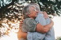 Head shot close up portrait happy grey haired middle aged woman snuggling to smiling older husband, enjoying tender moment at park Royalty Free Stock Photo