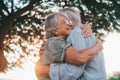 Head shot close up portrait happy grey haired middle aged woman snuggling to smiling older husband, enjoying tender moment at park Royalty Free Stock Photo