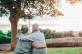 Head shot close up portrait happy grey haired middle aged woman snuggling to smiling older husband, enjoying tender moment at park Royalty Free Stock Photo