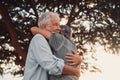 Head shot close up portrait happy grey haired middle aged woman snuggling to smiling older husband, enjoying tender moment at park Royalty Free Stock Photo