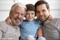 Portrait of happy three different generations bonding male family. Royalty Free Stock Photo