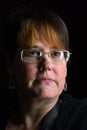 Head Shot of Confident Woman in High Contrast Window Light Royalty Free Stock Photo