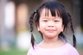 Head shot cute little girl looking at camera with smiling face. Girl labia is dry and chapped lips.