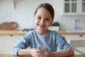 Headshot portrait little girl holding glass of still water Royalty Free Stock Photo